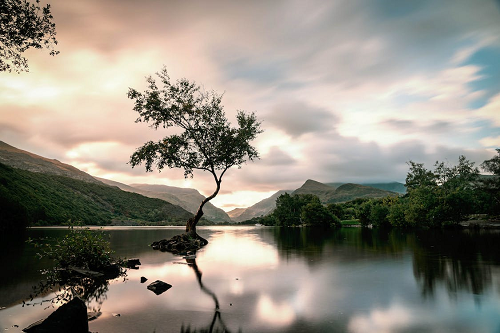 Calm lake with mountains in the background.